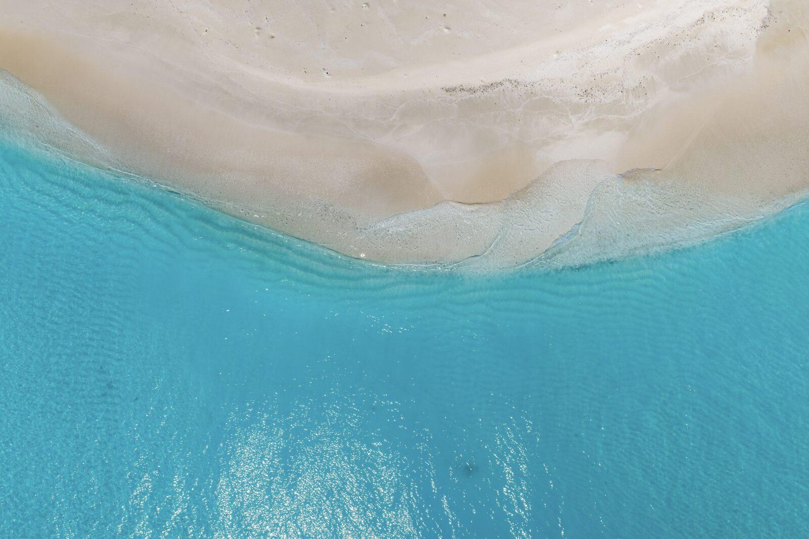 Overhead view of clear shallows and pale sand off Dhigurah