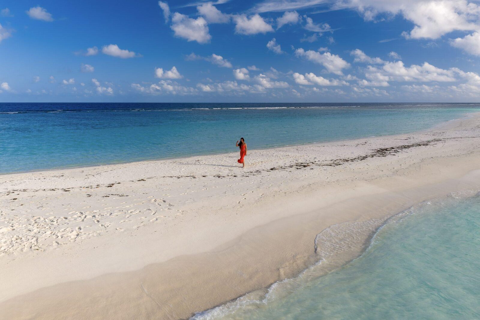 Dhigurah's long white sand beach meeting turquoise shallows, South Ari Atoll, Maldives