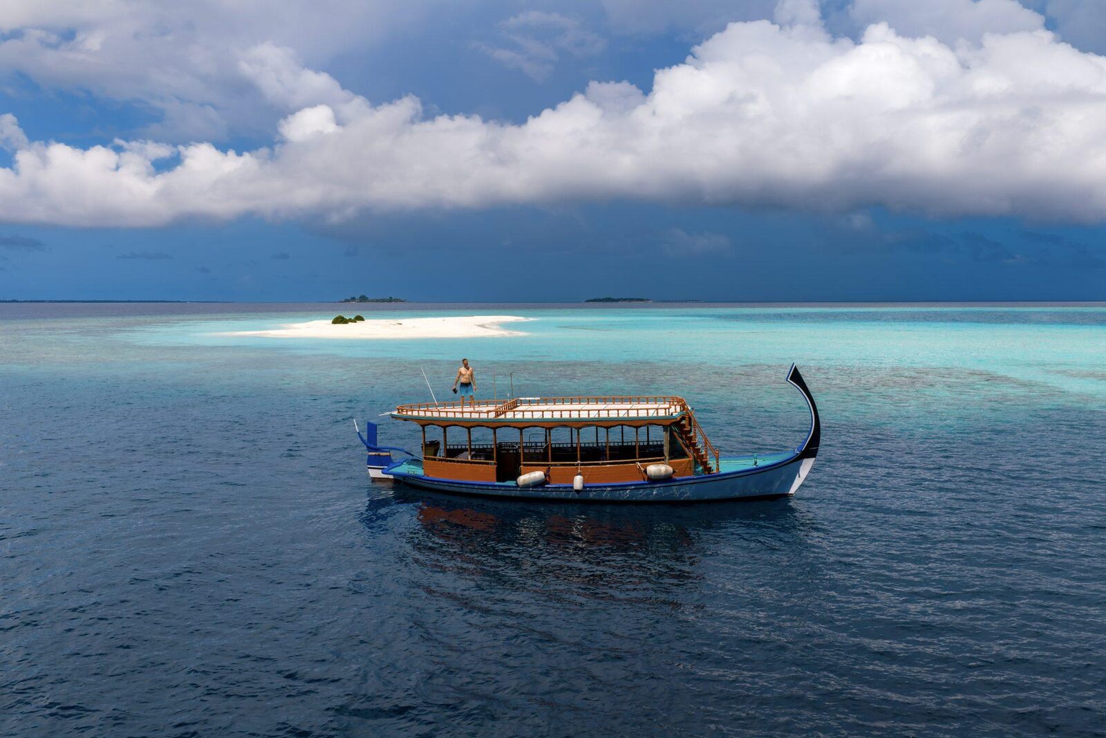A dhoni on turquoise water off Dhigurah, seen from the air